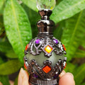 ornate black glass bottle on a leafy background