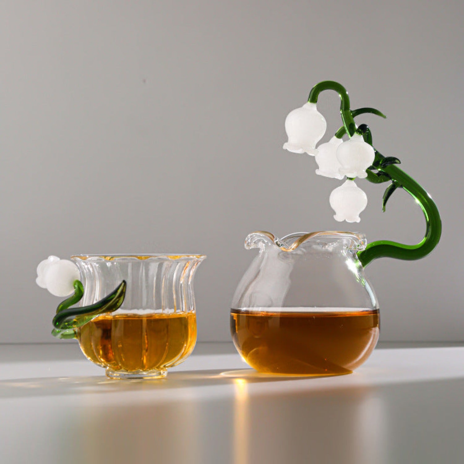 Glass tea set on white background