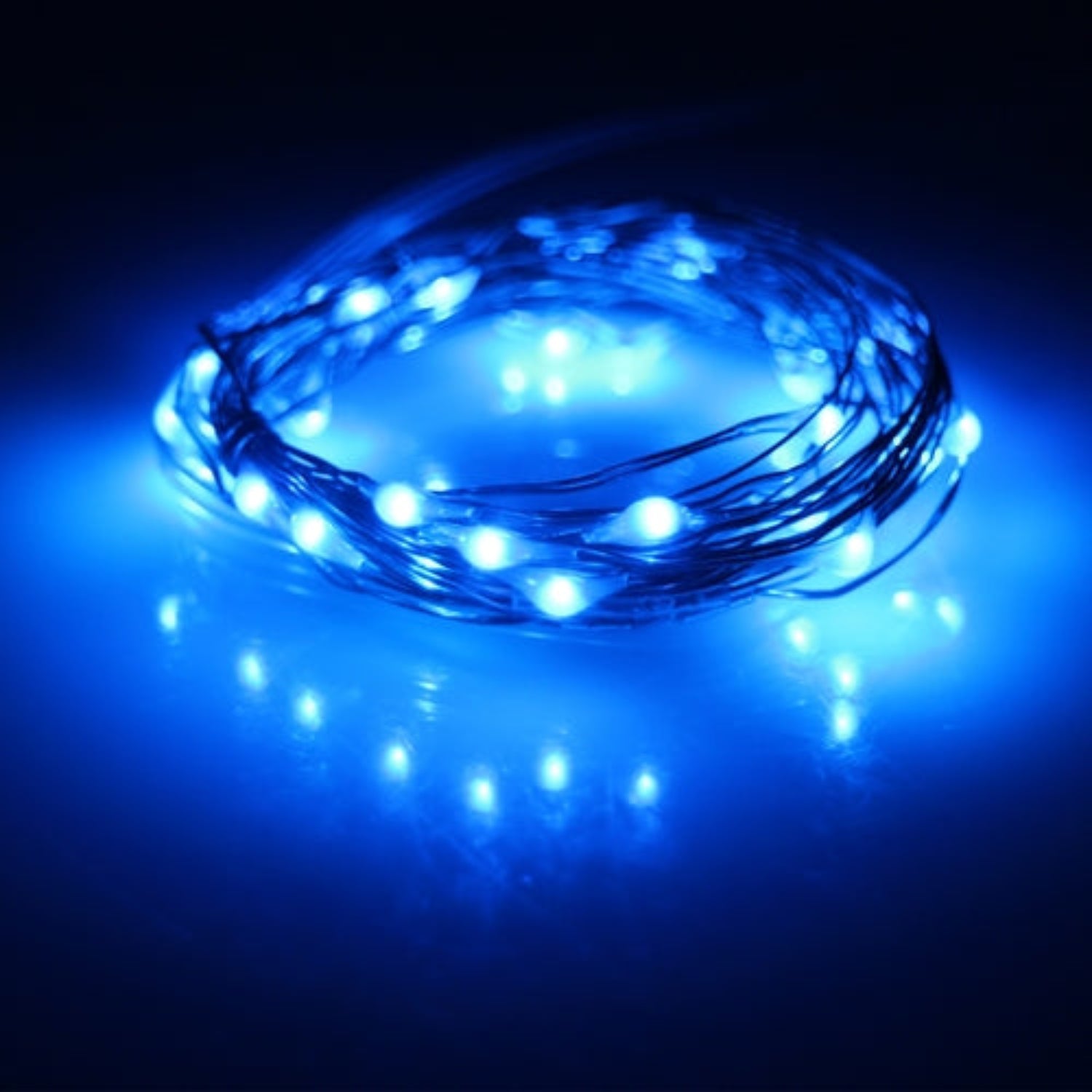 Coiled blue LED string light on a dark background