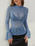 Model wearing the blue lace mock neck sheer‑sleeve top, front view.