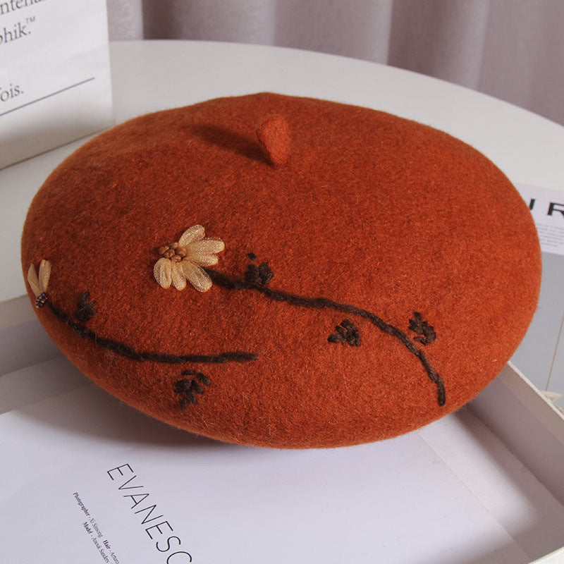 red daisy cap sitting on a white table