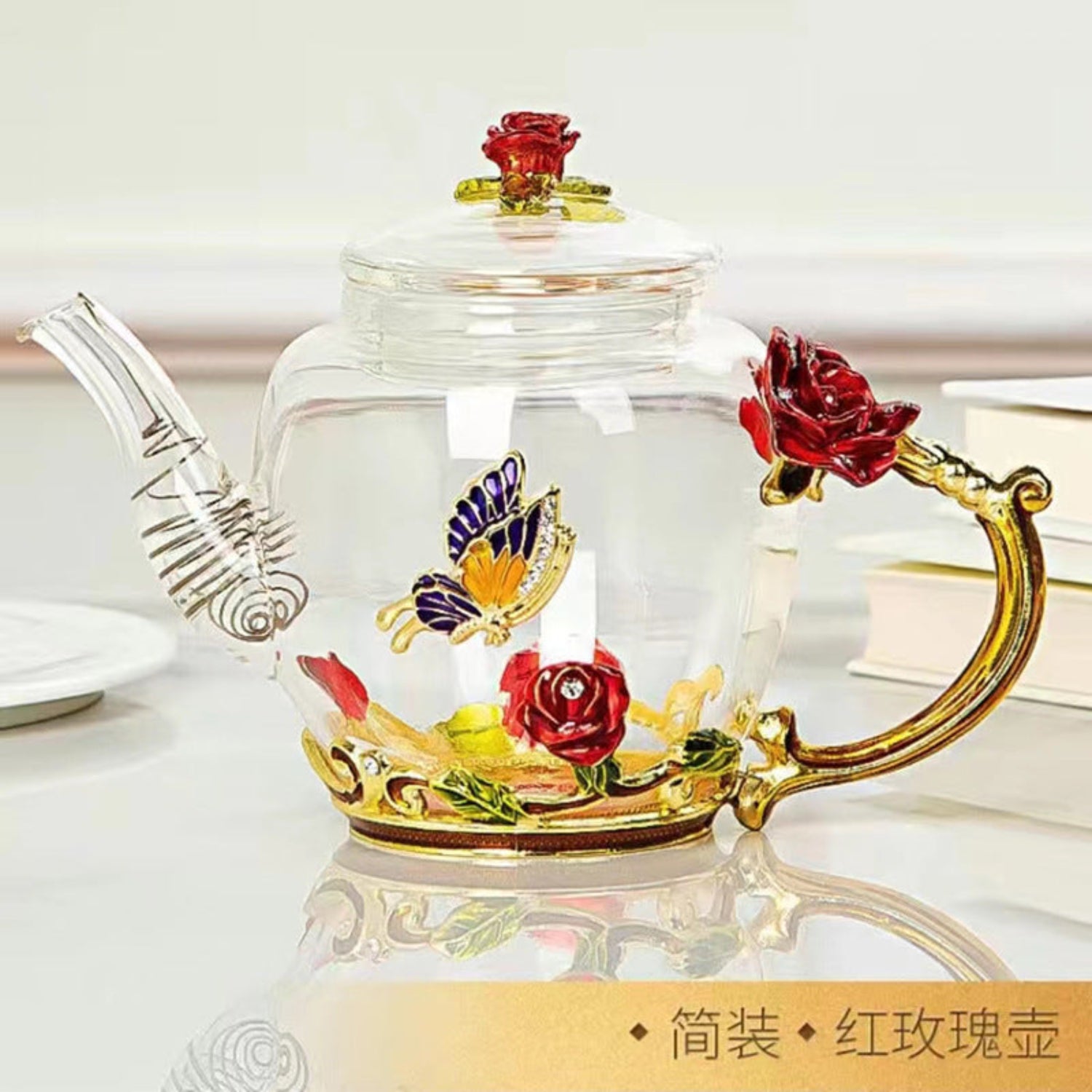 Decorative glass teapot with floral designs on a white background