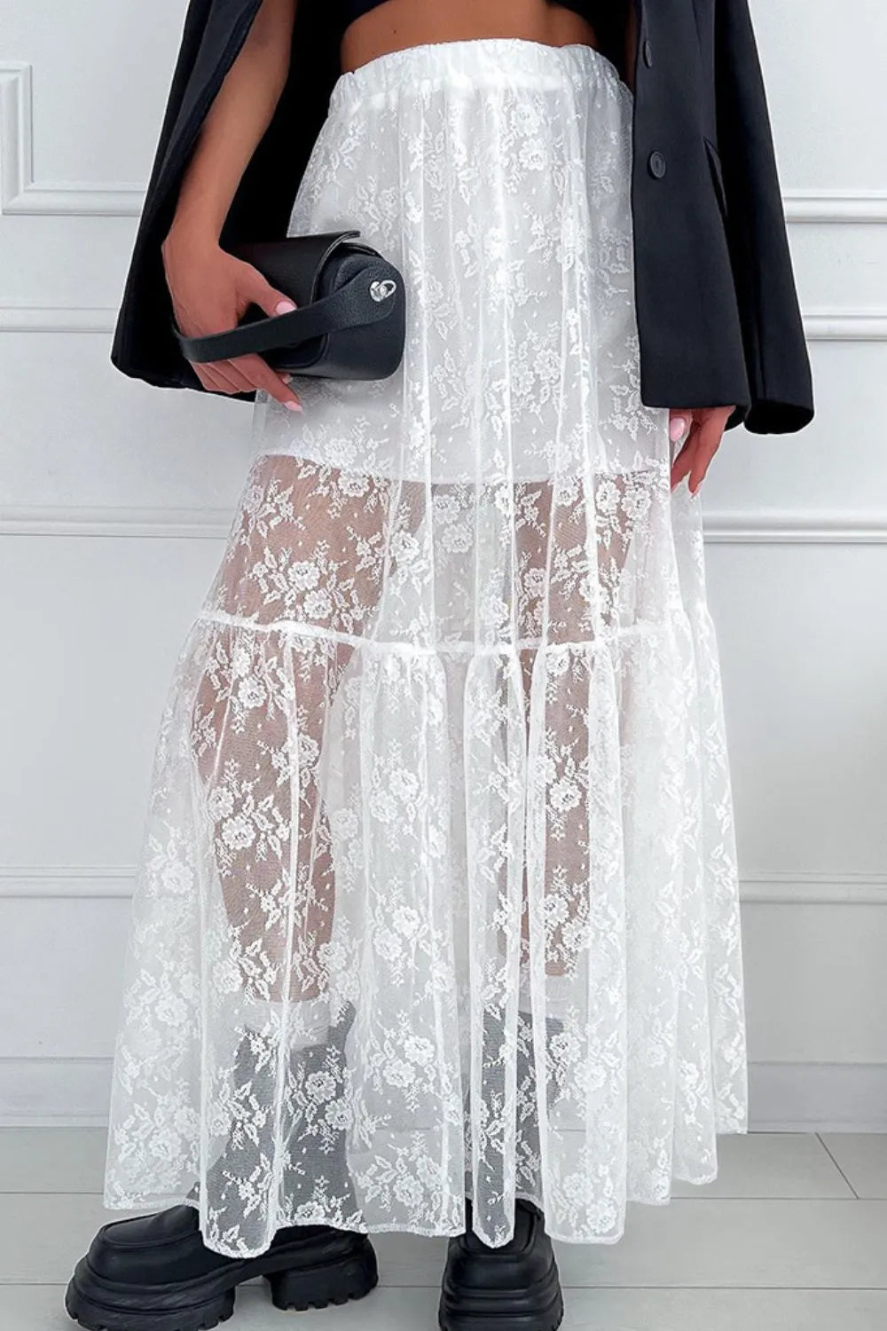 Front view of the white lace maxi skirt showing the elastic waist, lined body, and semi‑sheer lace overlay.