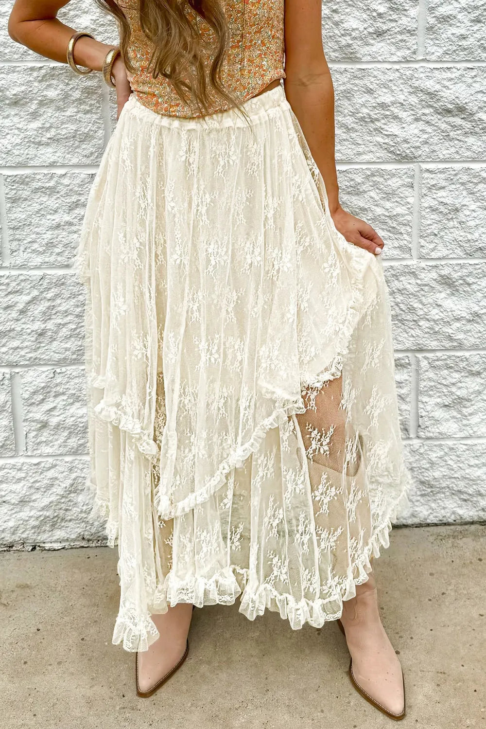 Third front view of the ivory lace midi skirt showcasing tiered design, semi‑sheer detailing, and elegant midi length
