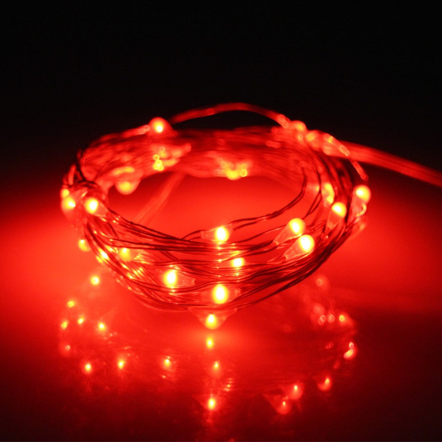 Roll of orange LED string lights on a dark background