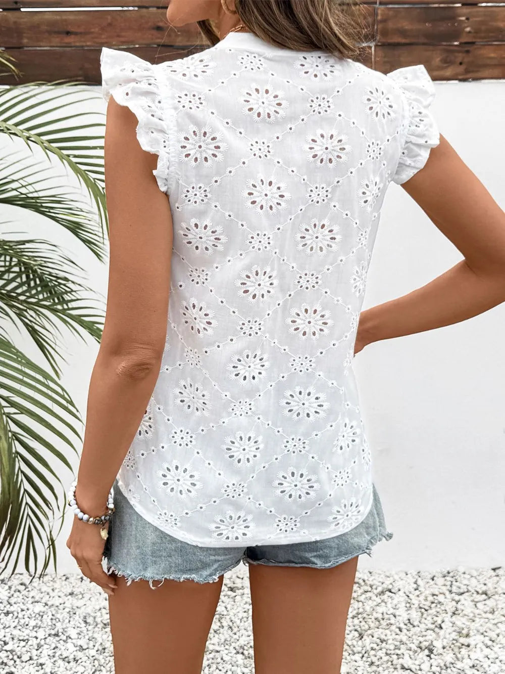 Back view of the white eyelet cap sleeve blouse showing full back design and lightweight summer fit.