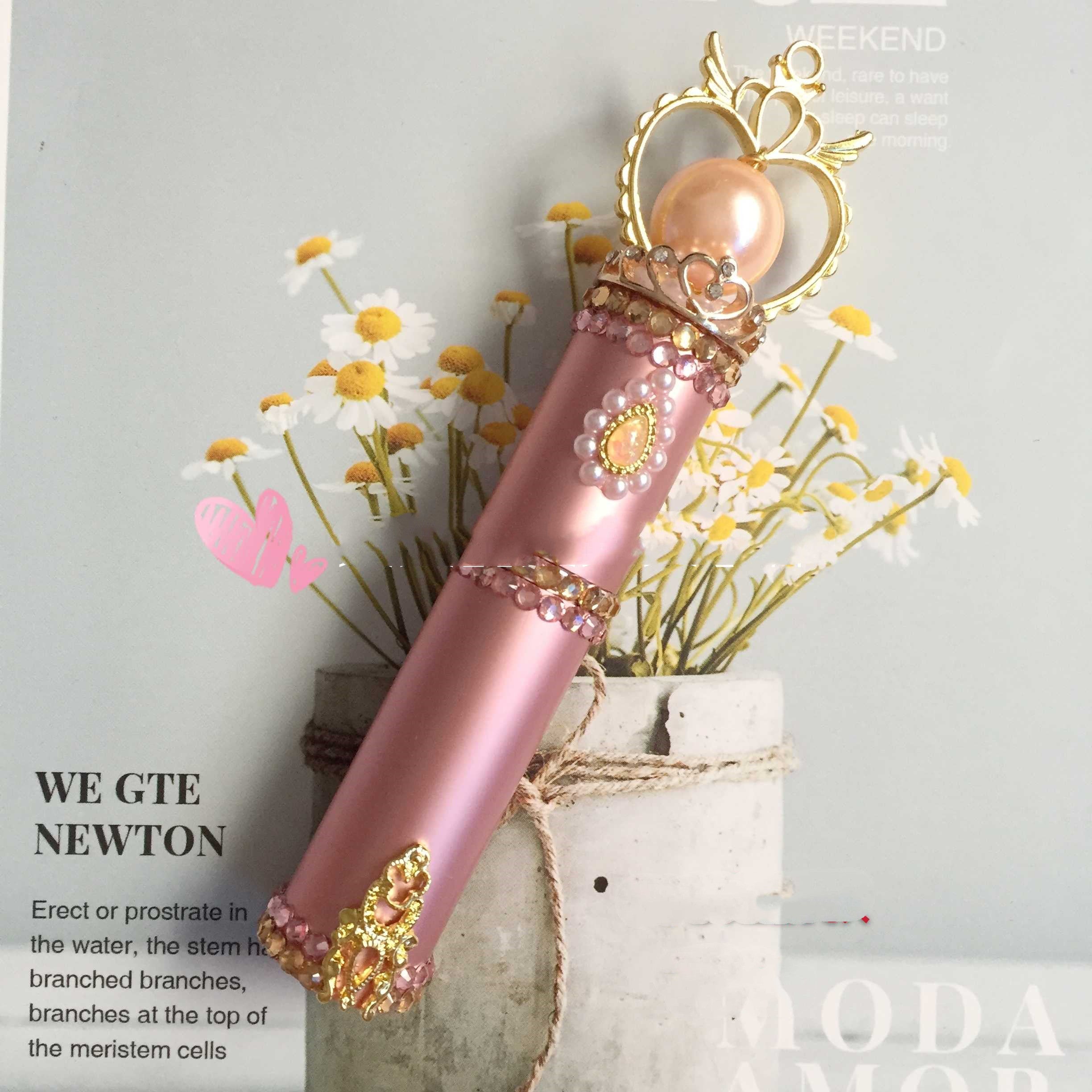 pink perfume bottle with heart on magazine background