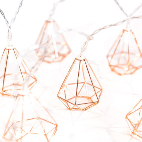 Geometric string lights with rose gold accents on a white background