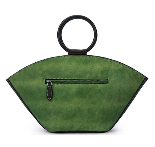 back view of a vintage‑style leather Boston bag with an embossed flower inside a bottle‑shaped motif.”