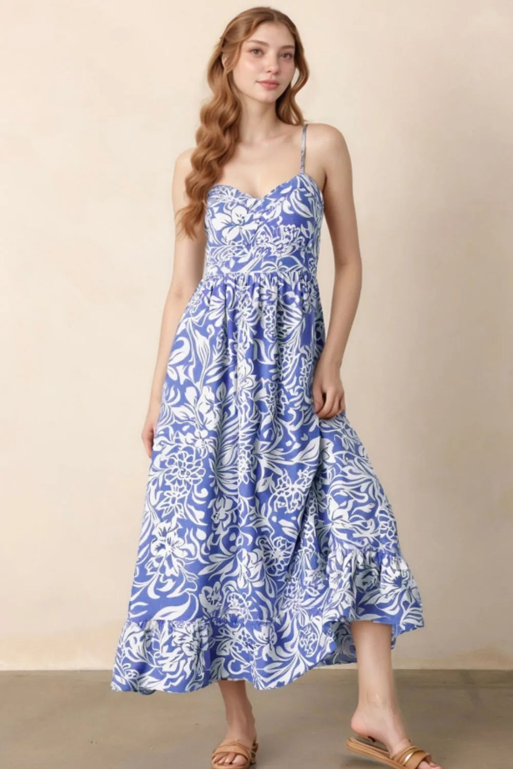 Model wearing the whimsical spaghetti‑strap sundress from the front, showing the soft ruffle hem and feminine fit.