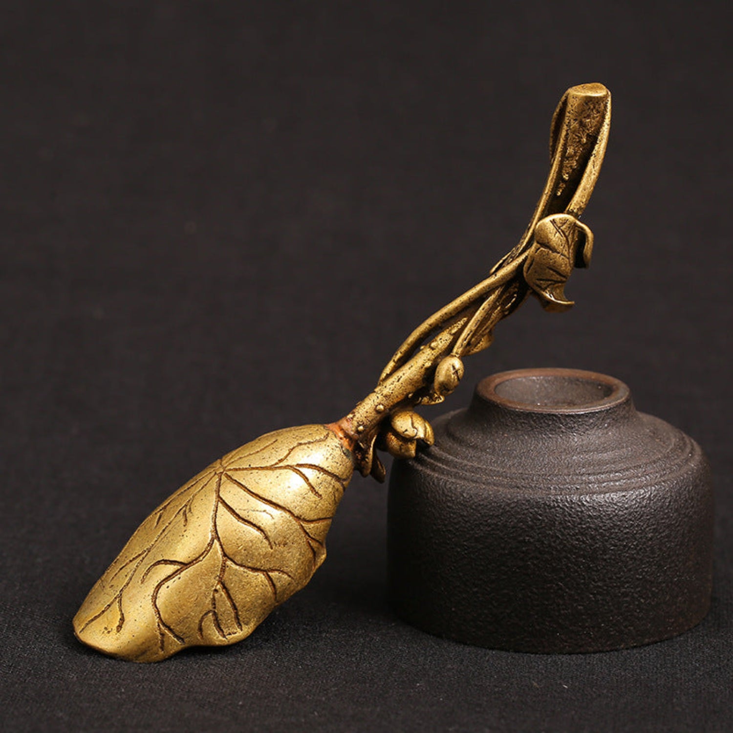 bottom view Pure brass lotus leaf tea shovel with a sculpted lotus flower and leaf‑shaped scoop, shown in a golden antique finish