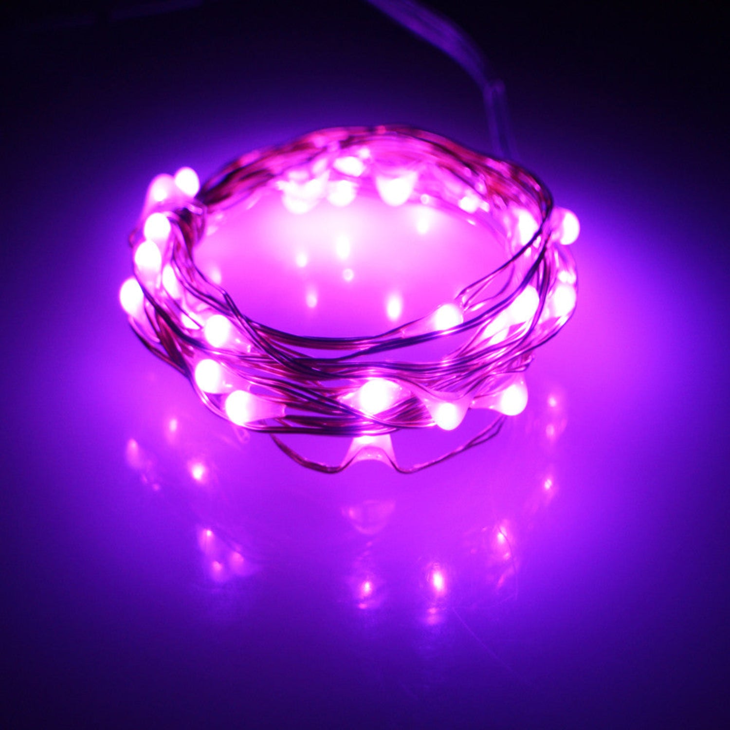 Pink LED string lights on a dark background