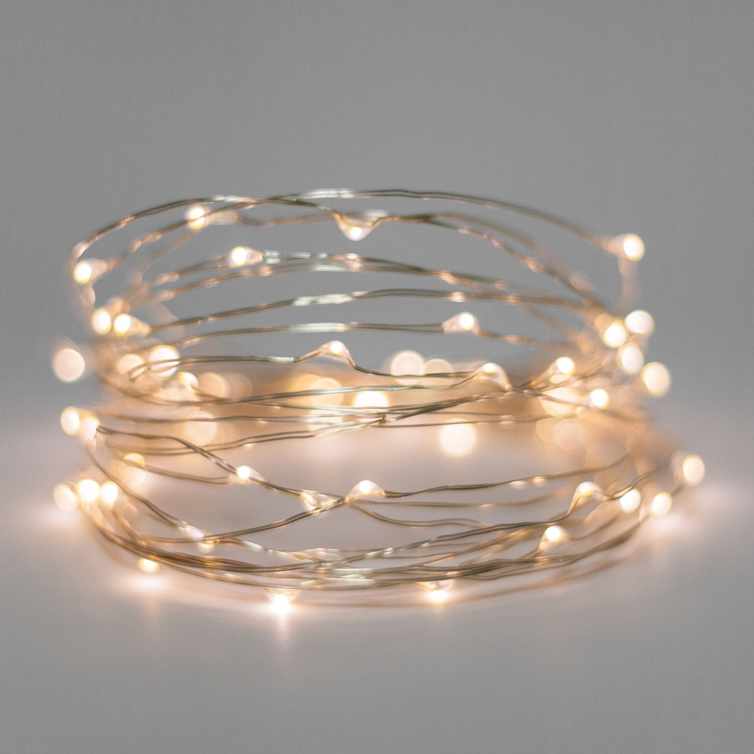 Coiled string of small lights on a gray background