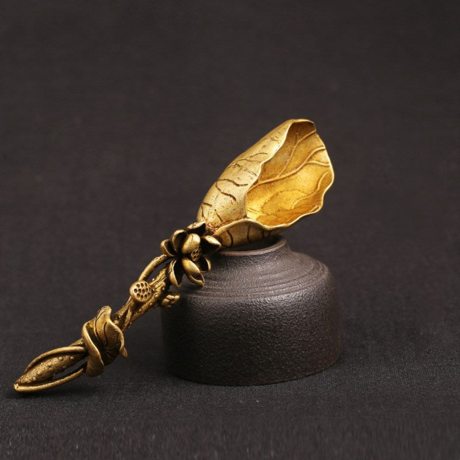 front view Pure brass lotus leaf tea shovel with a sculpted lotus flower and leaf‑shaped scoop, shown in a golden antique finish
