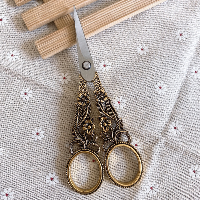 scissors on white floral background
