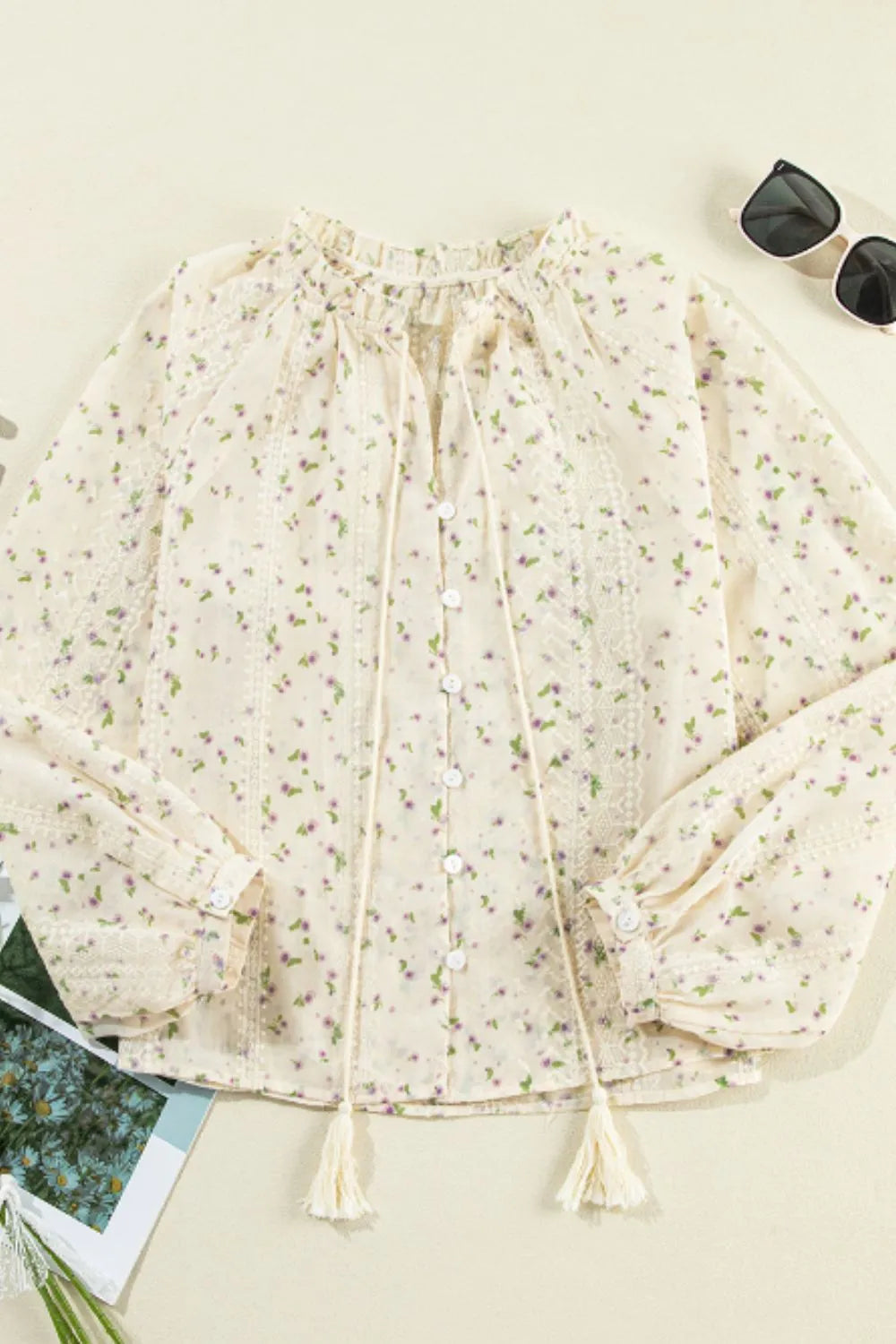 Flat lay of the lace frill printed tie‑neck blouse, showing the full design and details.