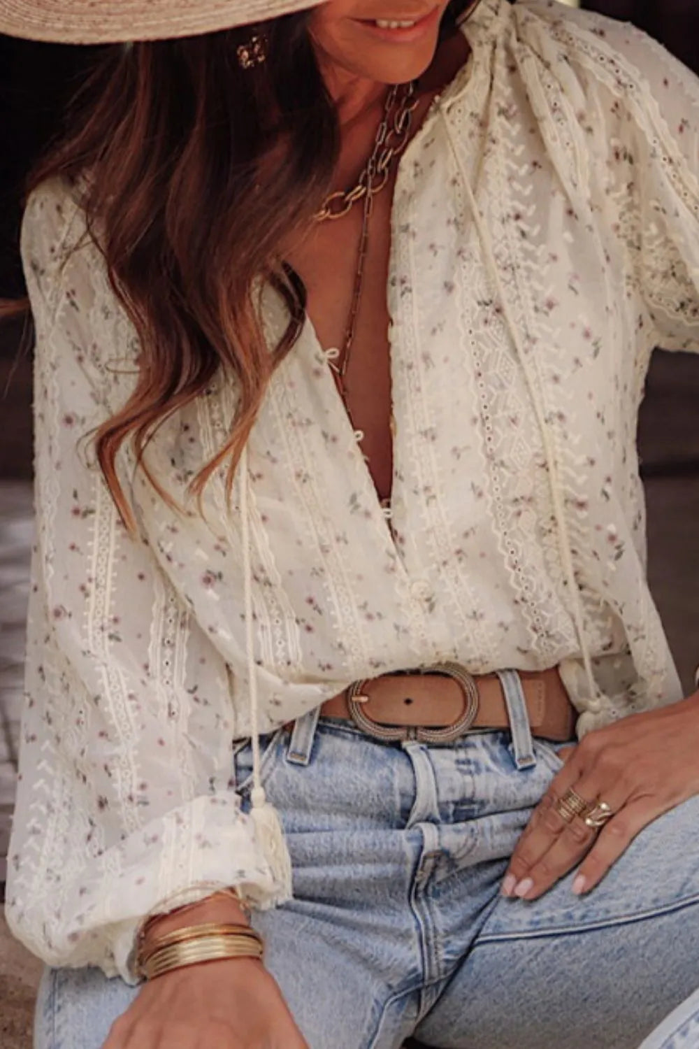 Front view of the lace frill printed tie‑neck long sleeve blouse on a model.