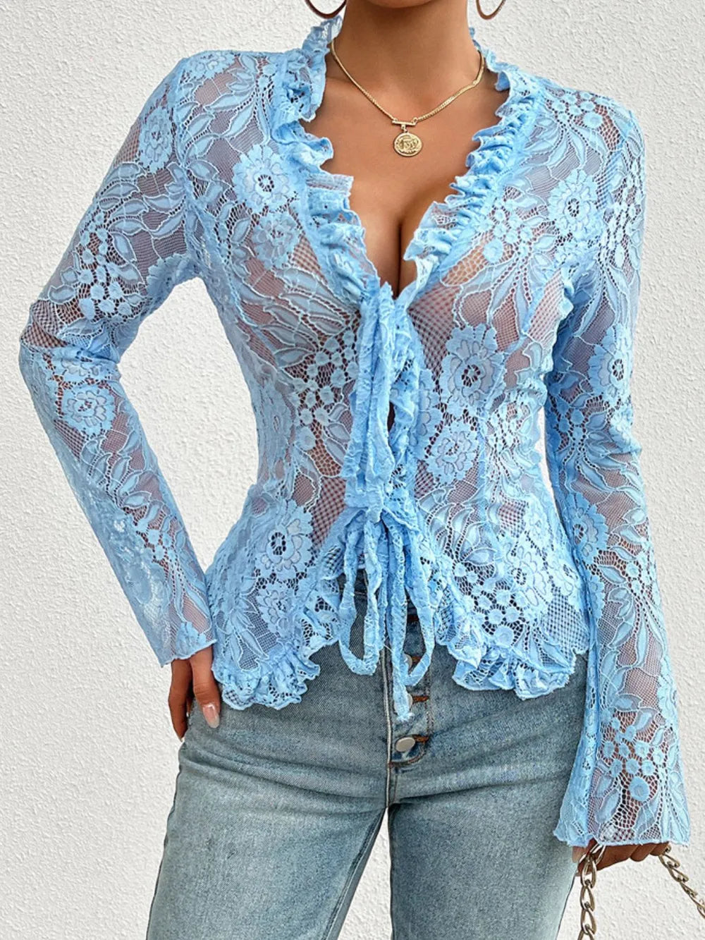 Blue lace top worn by a person on a light gray background