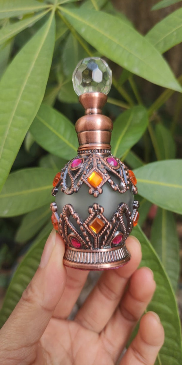 ornate silver bottle on a leaf background