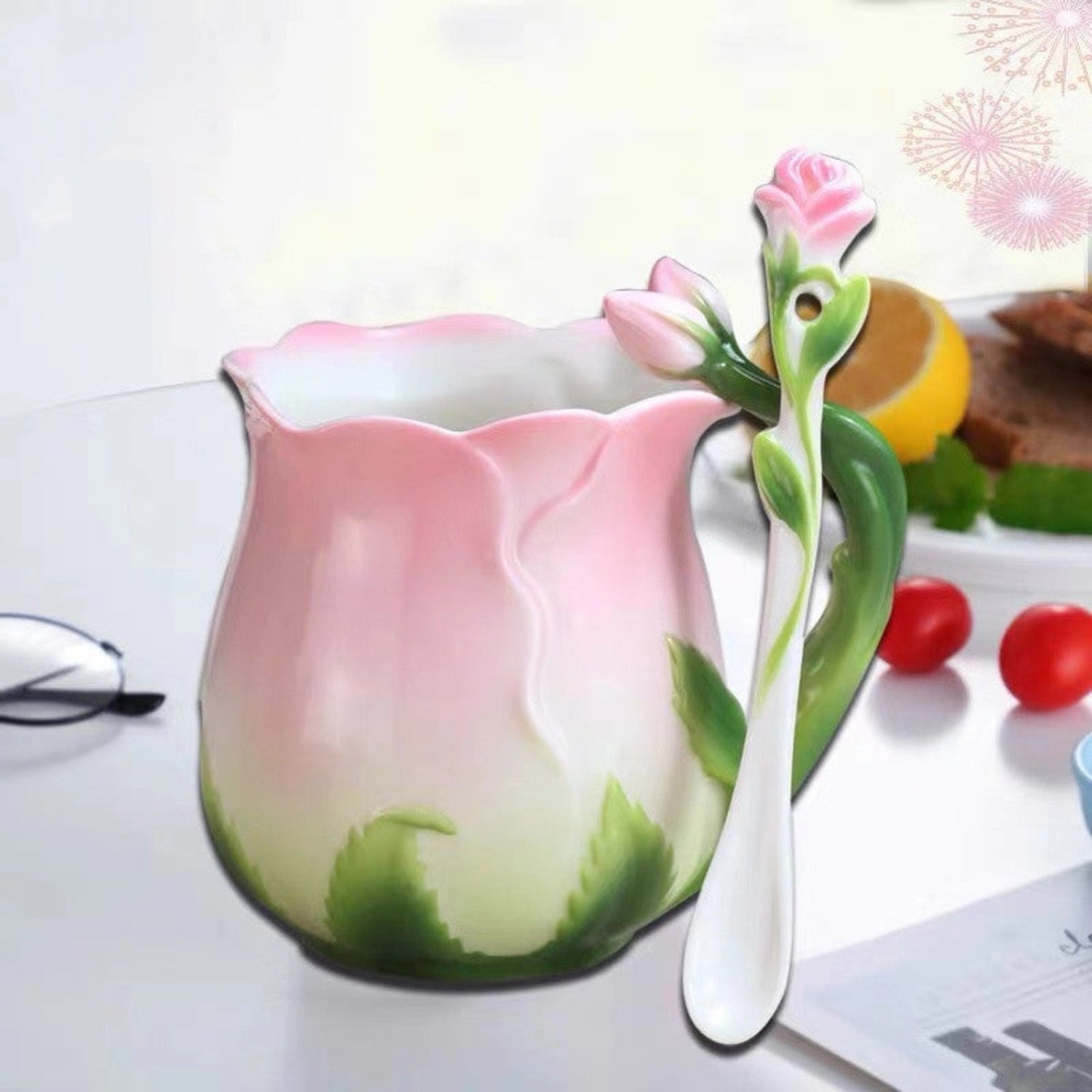 rosebud teacup and stirrer on a white table