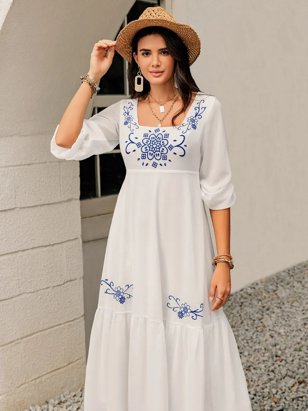 Model facing forward in the printed square‑neck dress, showing the airy balloon sleeves and feminine shape.