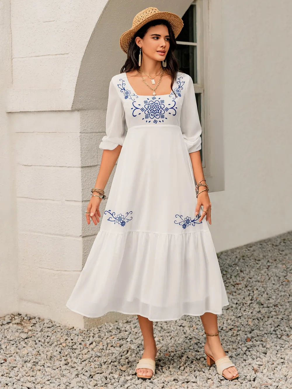 Another front angle of the floral square‑neck dress on the model, emphasizing the lightweight fabric and gentle drape.