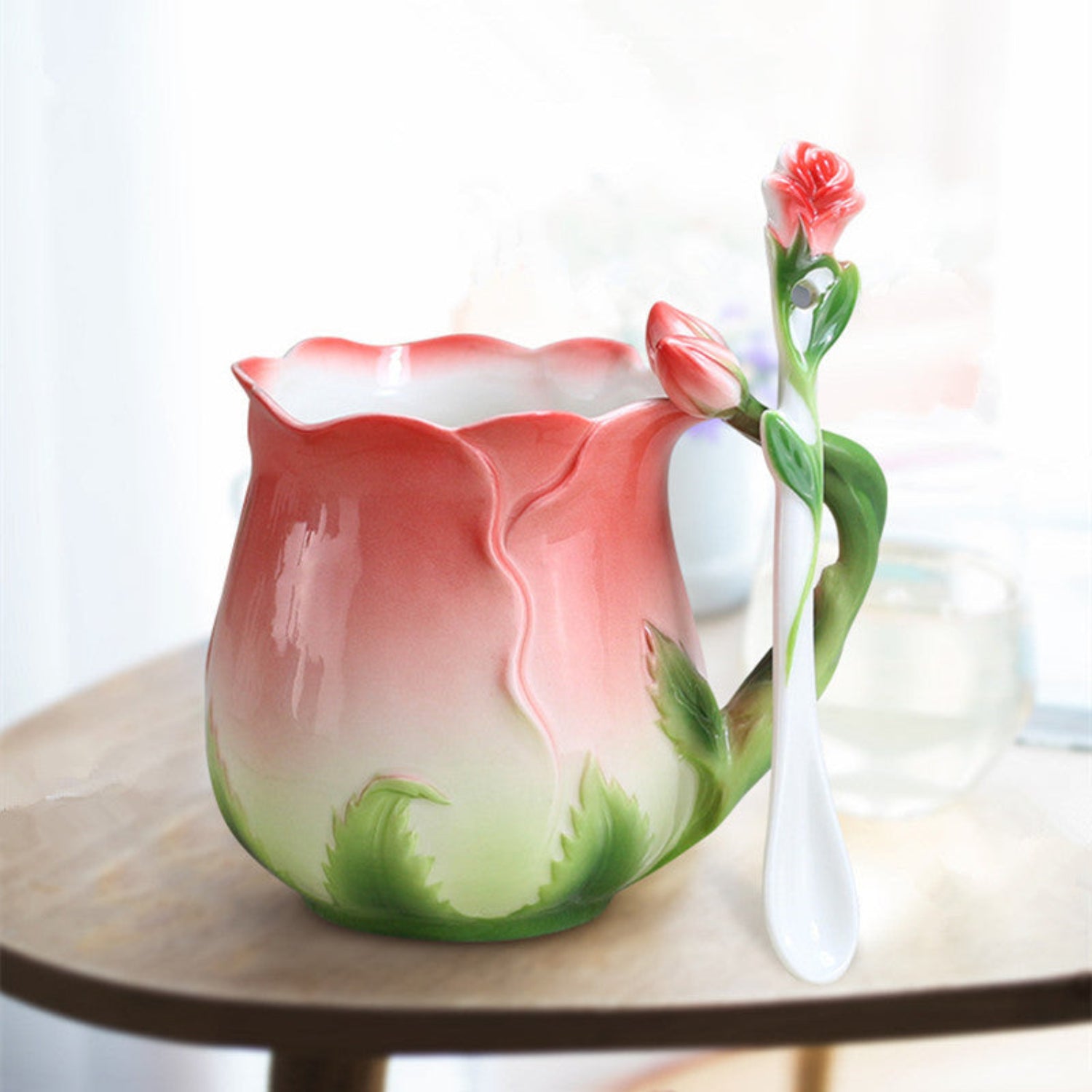 rosebud teacup and stirrer on a white background