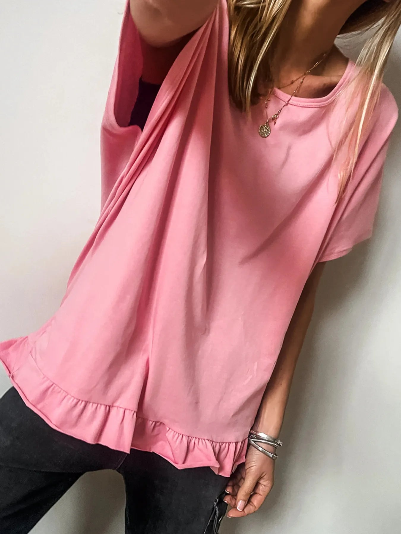 Model wearing the pale blush ruffle hem relaxed T‑shirt, shown from the front.