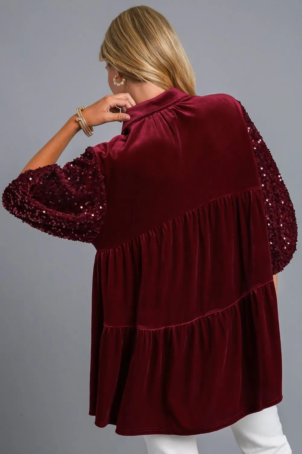 Back view of the wine Umgee top showing the flowing tiered back and sequin accents.
