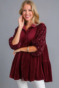 Front view of the wine Umgee sequin detail tiered back half sleeve top on a model.