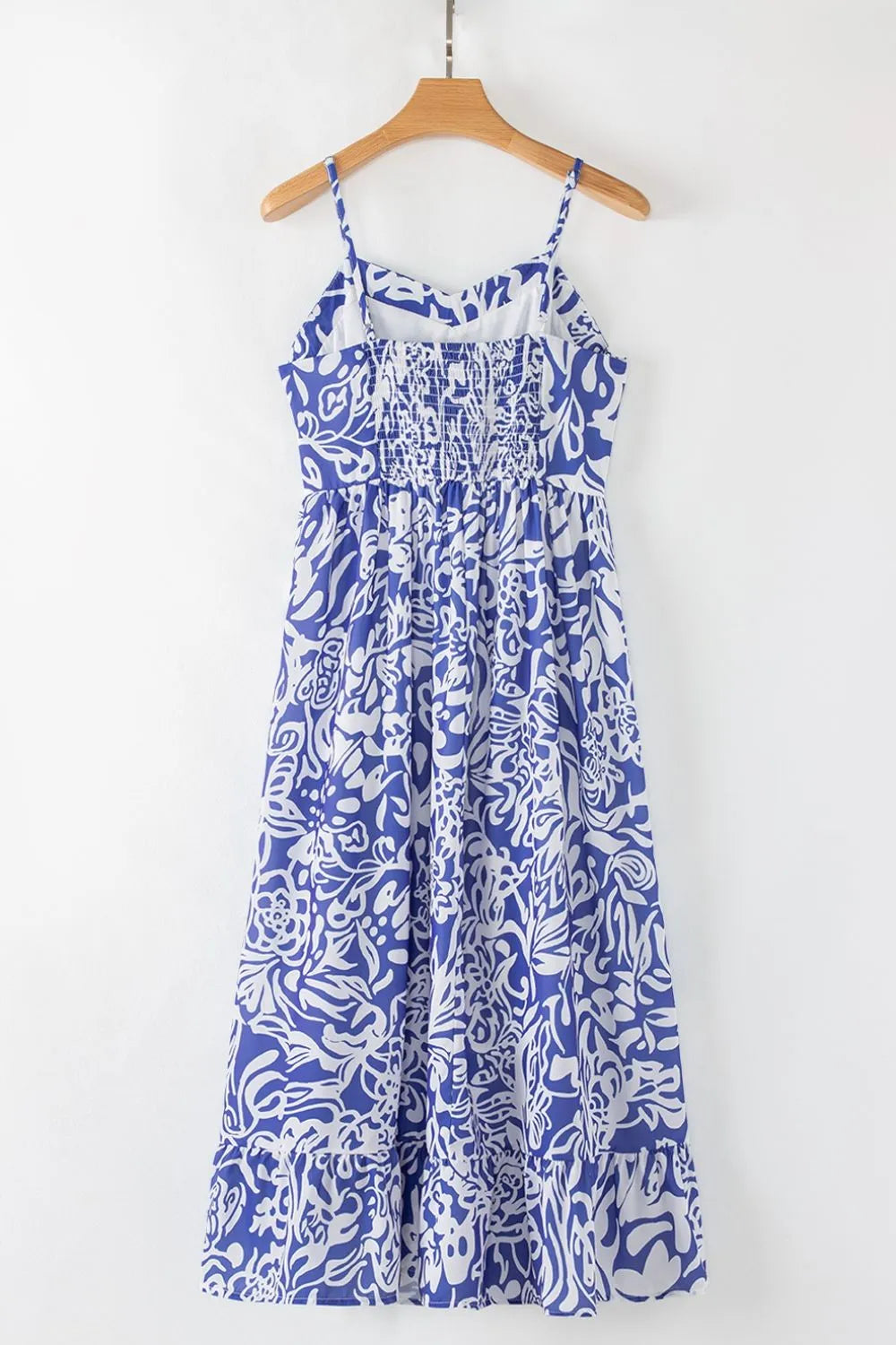 Back of the spaghetti‑strap sundress on a hanger, highlighting the clean back design and soft fabric texture.