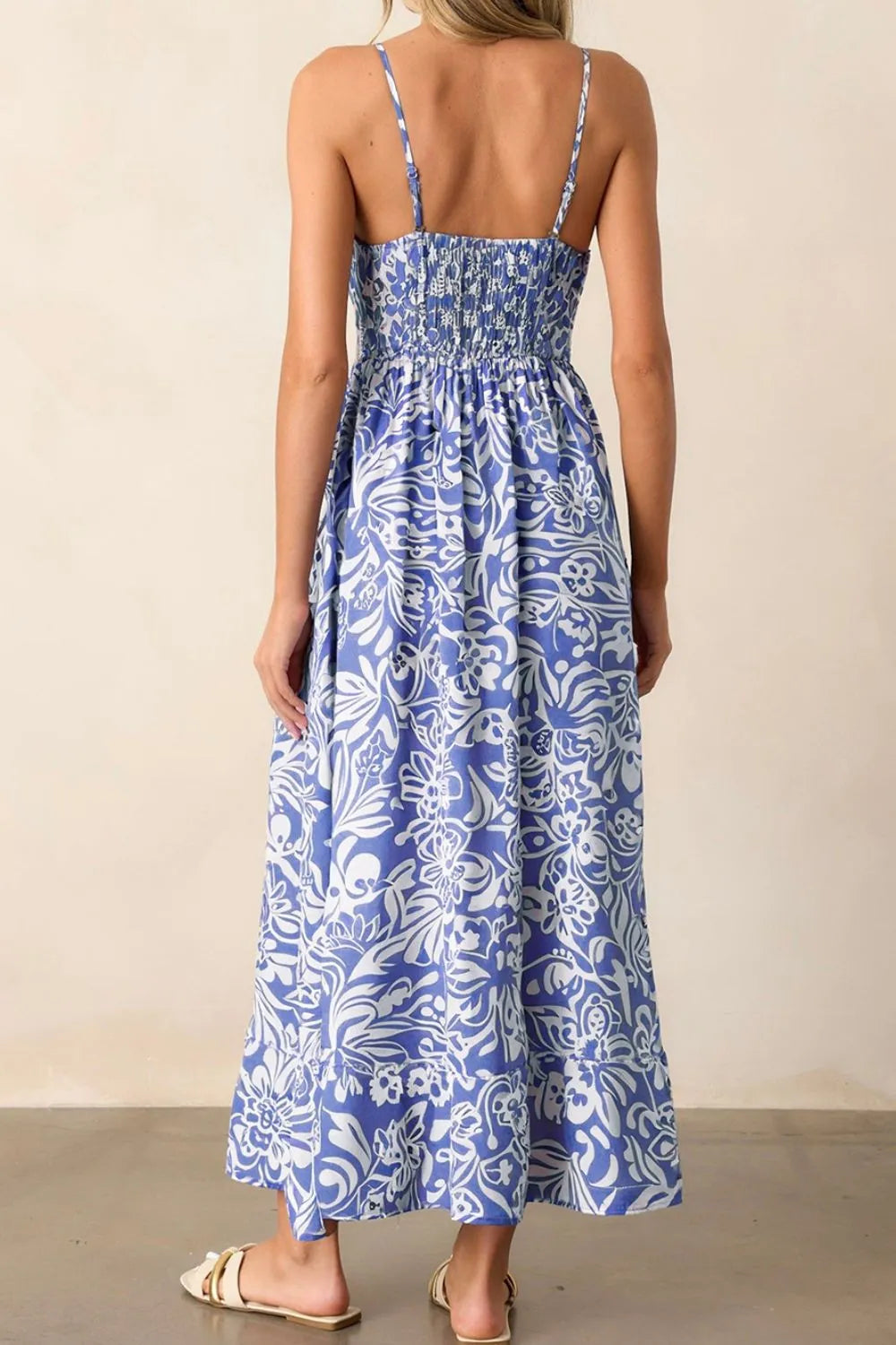 Back view of the spaghetti‑strap sundress on the model, showing the smooth back panel and gentle drape.