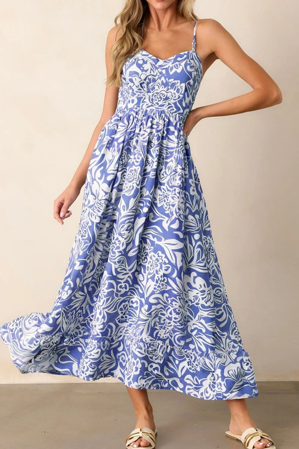 Second front view of the spaghetti‑strap sundress on the model, highlighting the delicate neckline and flowy silhouette.