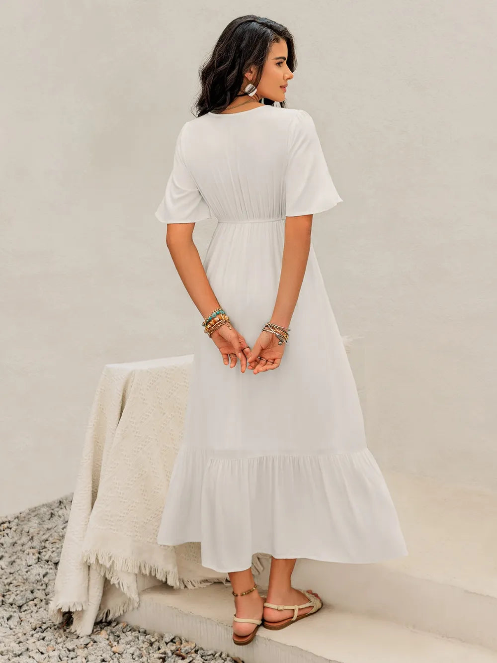  Back view of the White Briar Cottage Dress on the model, showing the smooth back and flowy skirt.