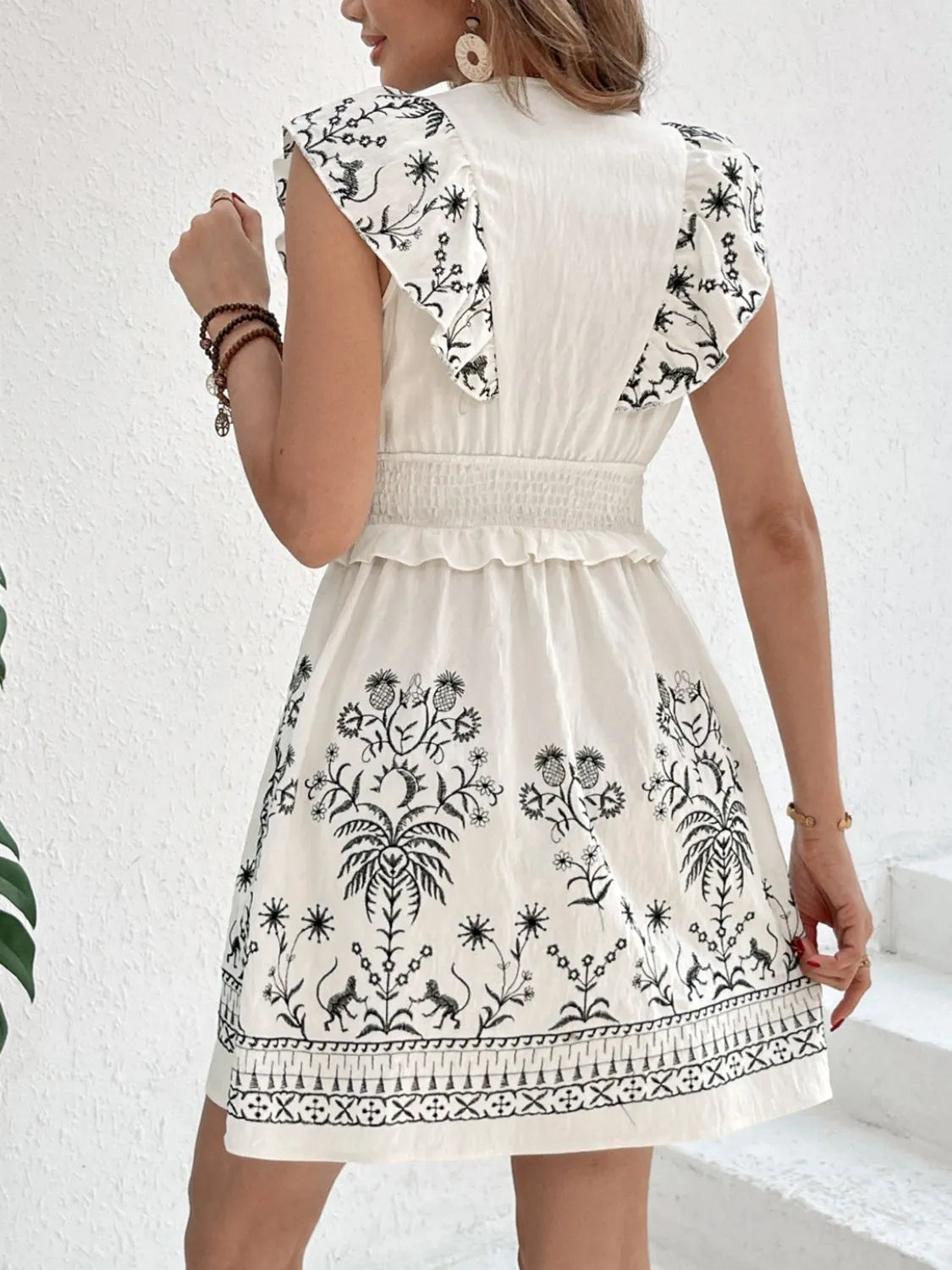 Back view of the Woodland Muse Smocked Mini Dress in cream, showing the smooth back and lightweight drape.