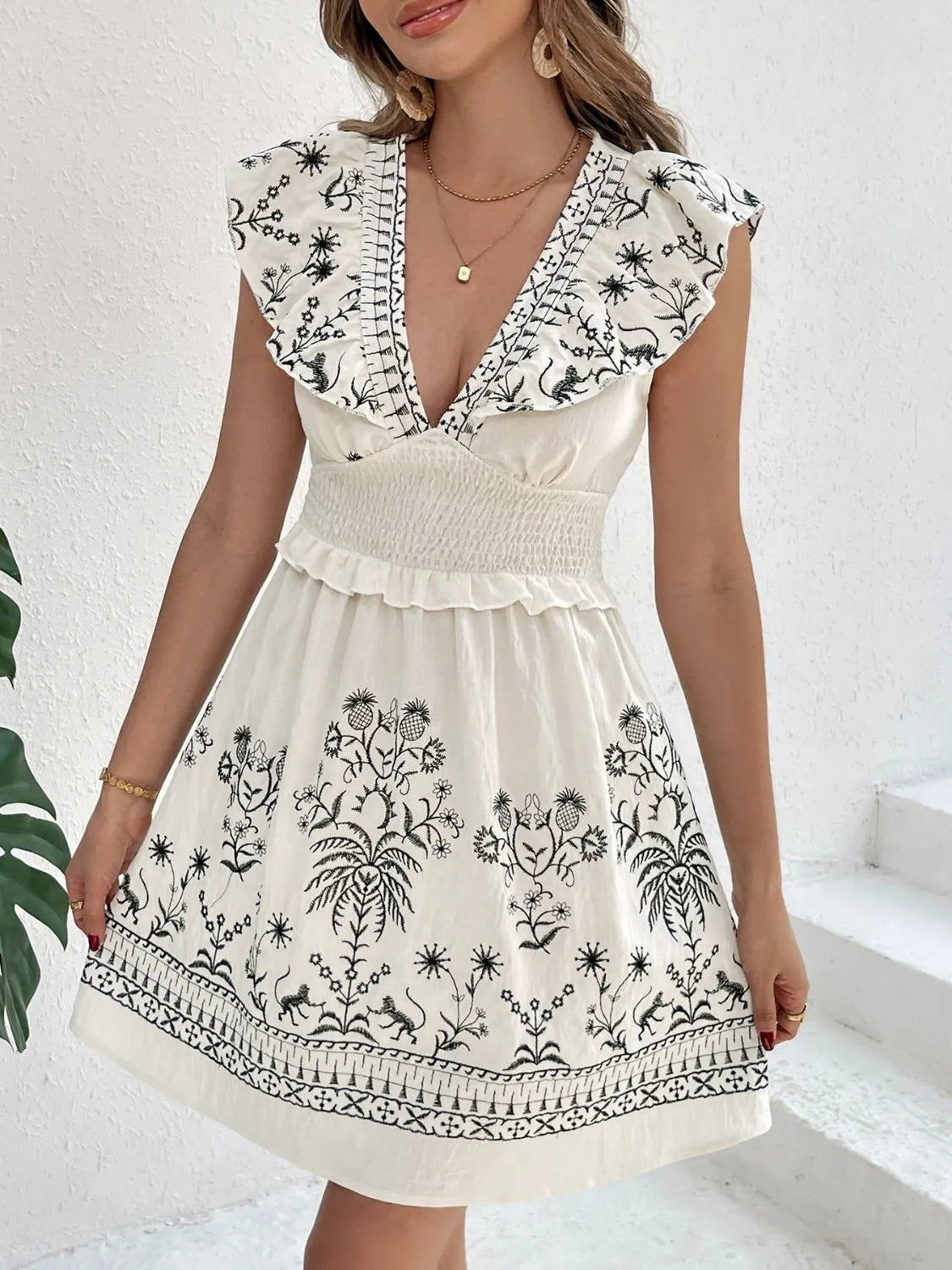 Front view of the Woodland Muse Smocked Mini Dress in cream on the model, showing the soft print and smocked bodice.